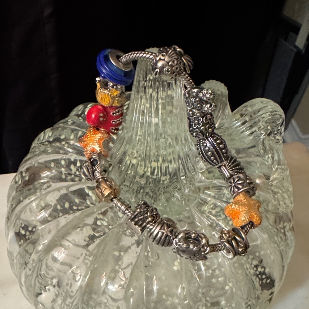 Pandora 14k Gold  and sterling bracelet with 16 rare charms.